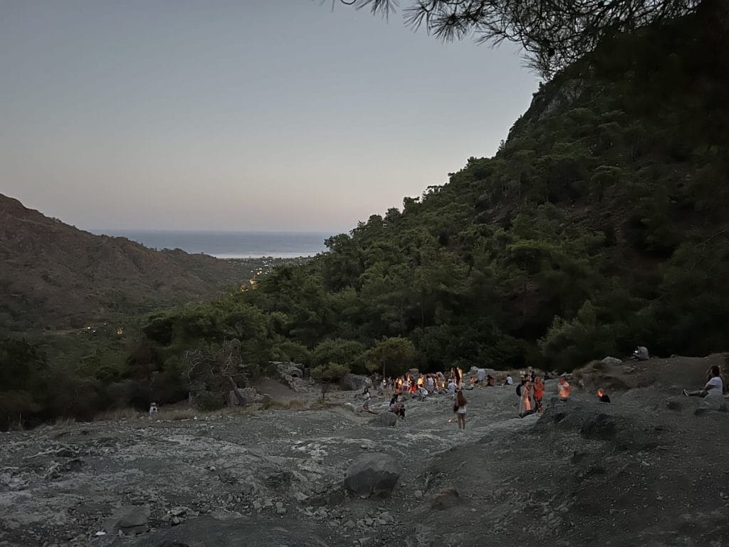 Crowd gathered at dusk at the burning rocks between Çıralı – Ulupınar.